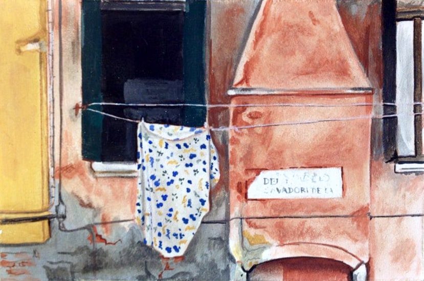 Painting of a colorful building facade with a patterned shirt hanging on a line across windows.