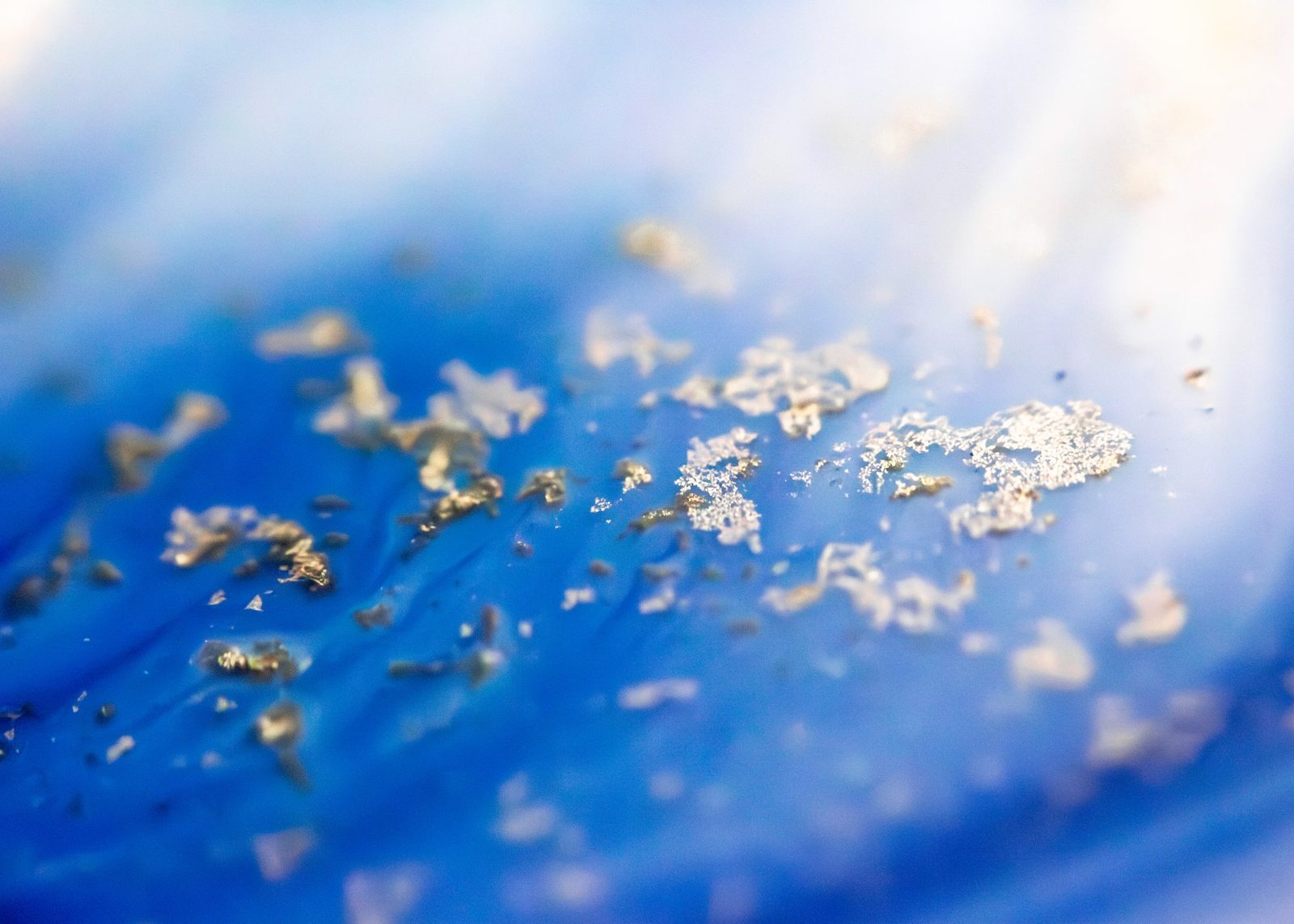 Cobalt blue ground scattered with clusters of gold metallic flecks.