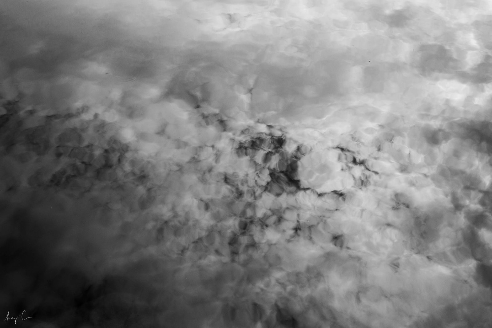 Textured grey and white cloud formations seen from above, filling the frame